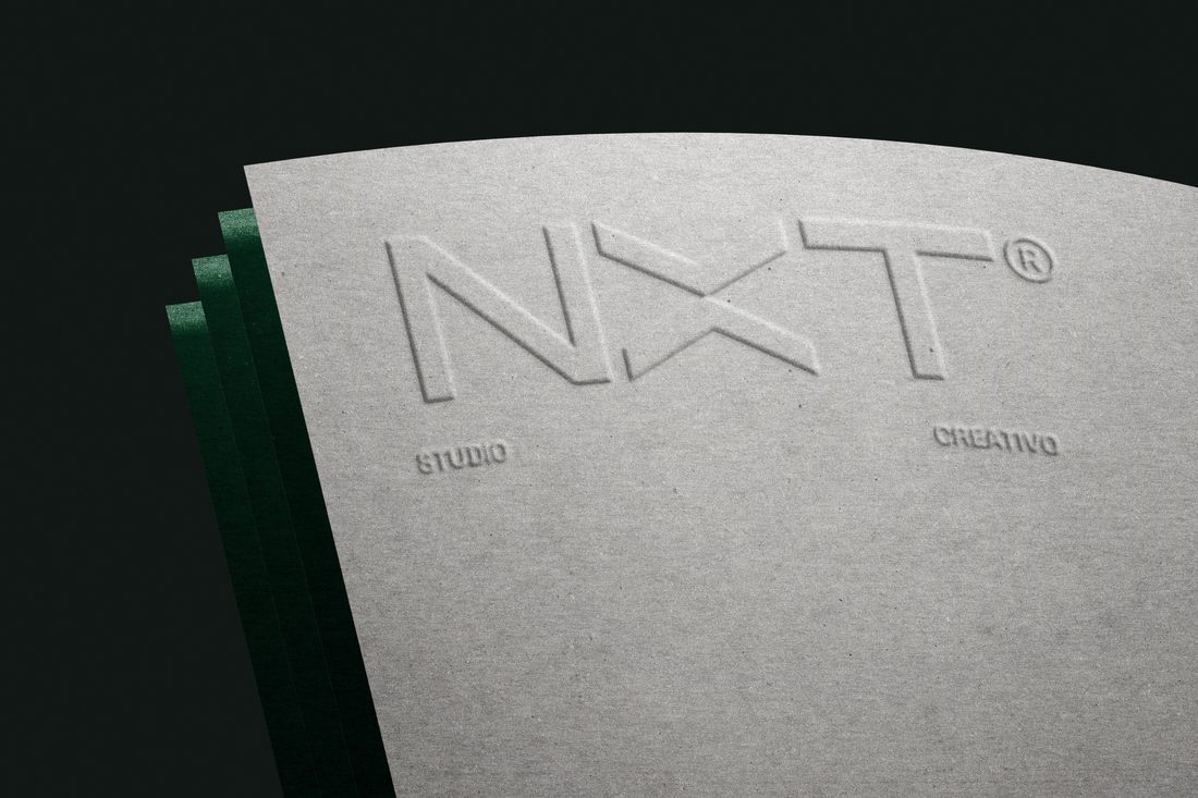 Isotipo NXT grabado en relieve sobre papel